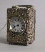 A late Victorian repousse silver miniature timepiece, Drew & Sons, London, 1896, 66mm.