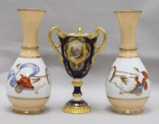 A Coalport three-handled pedestal vase and a pair of baluster vases decorated with Greek-style