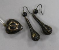 A pair of tortoiseshell and pique earrings and a similar heart shaped pendant.