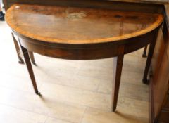 A George III mahogany demi-lune folding dining table W.132cm