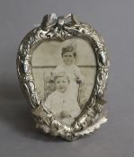 A late Victorian small silver mounted heart shaped photograph frame, decorated with thistles,
