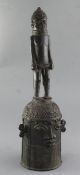 A Benin bronze bell, with standing man handle bearing the head of King Oba, 48cmProvenance: Ex.
