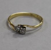 An 18ct gold and platinum, two stone diamond crossover ring, size M.