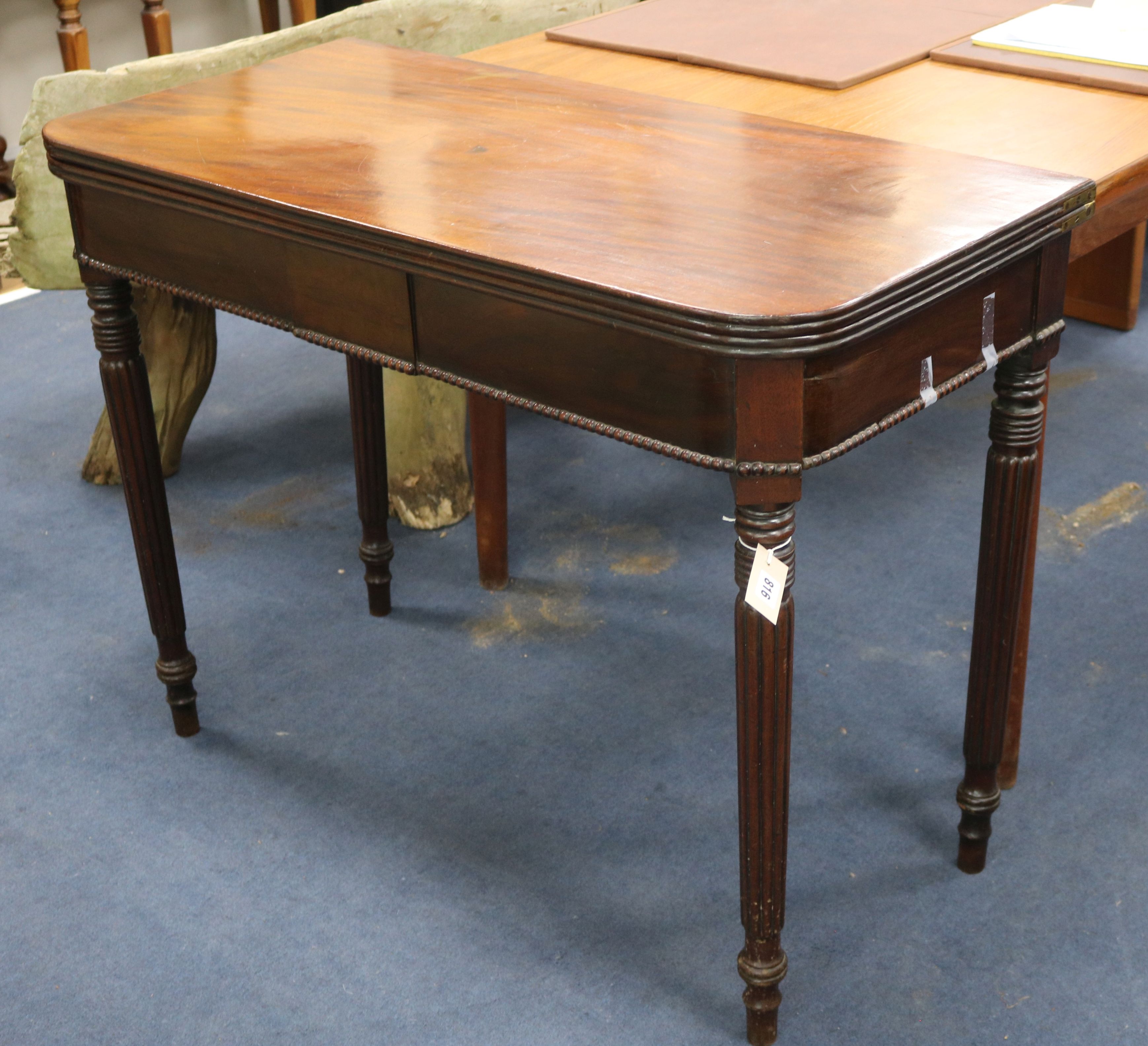 A mahogany tea table with reeded legs W.101cm