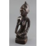 An African hardwood group of a kneeling woman holding an infant, 26cm