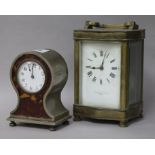 A brass carriage clock and a faux tortoiseshell timepiece