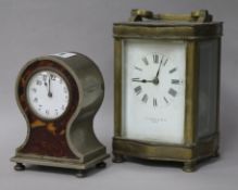 A brass carriage clock and a faux tortoiseshell timepiece