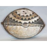 An elephant hide shield, with painted decoration and inscribed 'Robert Loc Kararromoki', 100cm