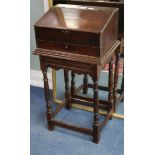 An 18th century mahogany slant front box, raised on an oak stand W.43cm