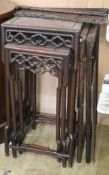 A Chinese nest of three carved hardwood tea tables, each with pierced frieze W.45cm approx.