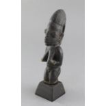 A Yoruba carved wood figure of a kneeling woman, 23cm, plus stand