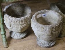 A pair of stone urns W.22cm