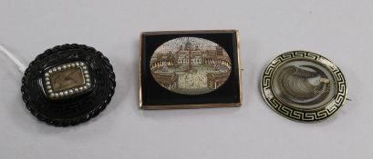 A 19th century Italian micro-mosaic brooch of St Peter's and two Memento Mori brooches