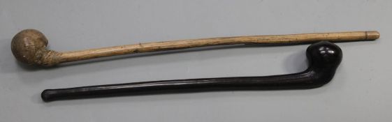 Two hardwood war clubs, one in a dark wood with a pointed knob, 58cm, the other bleached burr
