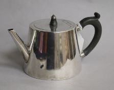 A Victorian silver teapot, of plain tapered cylindrical form with ebonised handle, London 1860;