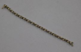 A yellow metal and diamond set wavy line bracelet, 18cm.