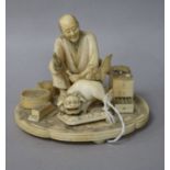 A Japanese Meiji carved ivory group of a wood carver (a.f.)