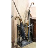 A cast iron stick stand and umbrellas etc. W.43cm