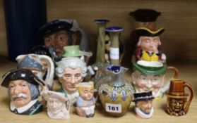 A group of Doulton and other character jugs and three Doulton vases