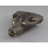 A Papua New Guinea carved and painted wood dog's head canoe prow, with shell inset eyes, 26cm