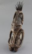 A Goroka Valley hardwood figure, with bone inset eyes and beaded details, from the collection of