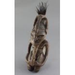 A Goroka Valley hardwood figure, with bone inset eyes and beaded details, from the collection of