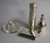 A 1920's silver figural hand bell, a silver toilet jar, silver mounted match strike and a silver