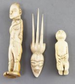 Two West African ivory storyteller figures, c.1900 and a hair ornament carved with a mask, largest