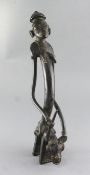 A Sao / Katoko bronze divination figure of a female woman holding a staff of power, seated upon a