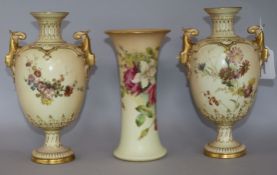 A pair of Royal Worcester blush ivory twin-handled pedestal ovoid vases and a similar tapered