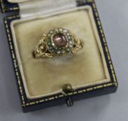 An early 19th century yellow metal, foil backed rock crystal and seed pearl ring, with carved