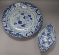 An 18th century Chinese blue and white dish and a double lipped sauceboat, dish diameter 35cm (