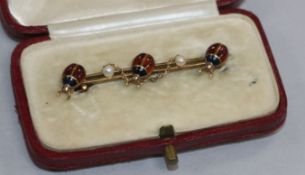An Edwardian 15ct gold, seed pearl and enamel triple ladybird bar brooch. 43mm.