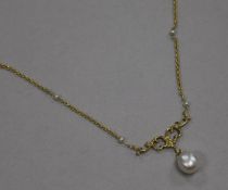 An early 20th century 18ct gold and cultured? pearl drop necklace, the chain set with seed pearls,