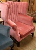 A George III style pink dralon upholstered wing armchair