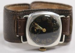 A WWI silver manual wind Officer's black dial wrist watch.