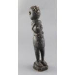 An African stained carved figure of a woman, with inset ears, 34cm