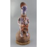 An Ibo People of Nigeria painted terracotta shrine vessel, surmounted with the figure of a seated