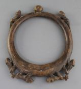An African? carved wood hoop necklace, decorated with a bearded mask and monkeys, 31cm