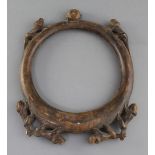 An African? carved wood hoop necklace, decorated with a bearded mask and monkeys, 31cm