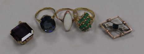Two 9ct gold rings, a 14ct gold gem set ring, a yellow metal and gem set brooch and a yellow metal