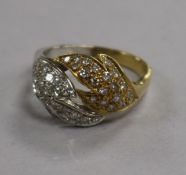 A stylish two colour 18ct gold and diamond cluster set dress ring, size O.
