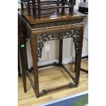 A Chinese huali wood urn stand, having panelled top and pierced frieze W.52cm