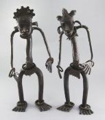 A pair of Nigerian bronze cham chams or protection figures, with ring bracelets to the wrist and