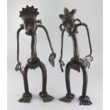 A pair of Nigerian bronze cham chams or protection figures, with ring bracelets to the wrist and