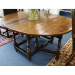 An early 18th century walnut oval topped gateleg dining table W.159cm