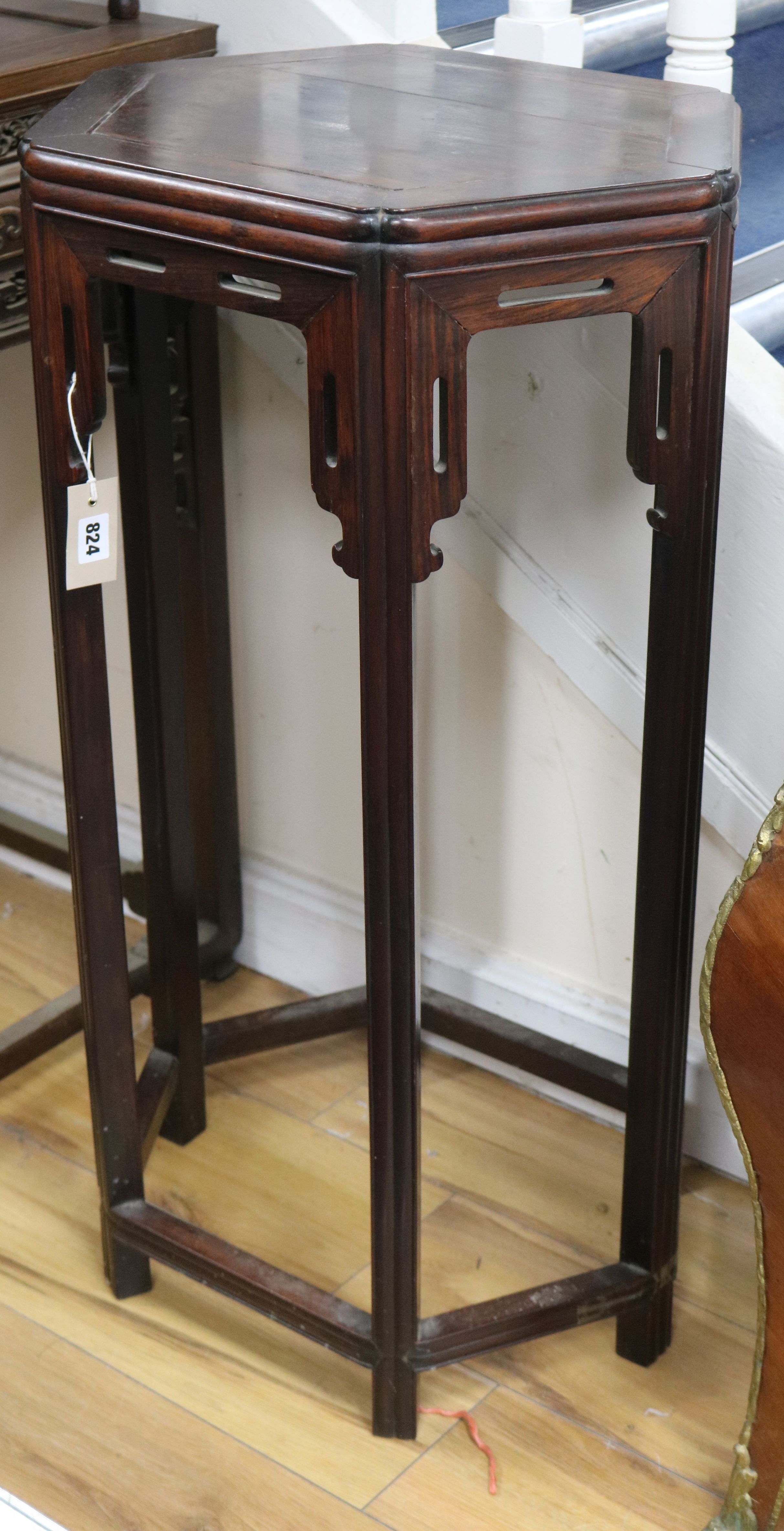 A Chinese huali wood urn stand of hexagonal form W.48cm