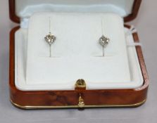 A pair of 18ct white gold and solitaire diamond ear studs, with a total carat weight of