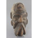 An African carved wood mask, with traces of applied decoration, 32cm