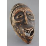 An African carved and stained wood mask, 36cm